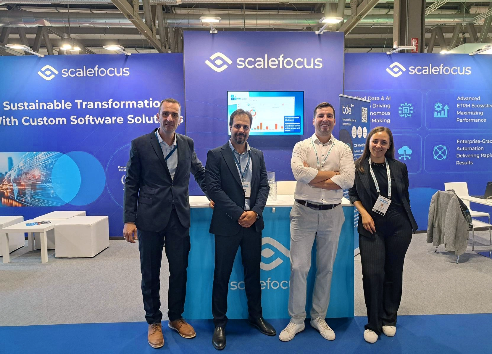 Scalefocus team at Gastech 2025 in Milan, standing together in front of their booth, with branding visible in the background. 